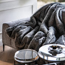 Discover the epitome of comfort with our Gray Faux Fur Throw This best-selling item brings timeless elegance to any space. The exceptional design elevates the style of your living room, bedroom, or lounge, introducing an ambiance overflowing with luxury, comfort, and timeless elegance. Perfect for high-end interiors, these accessories add a refined and cozy touch to any modern living space. Whether you're styling a sleek lounge or adding warmth to both minimalist ad traditional interiors.