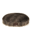 Cozy oval dog bed made of dark eco-friendly faux raccoon fur. Offers orthopedic support while soothing separation anxiety with its warm, nest-like design.