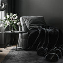 A close-up reveals the unique texture of the “Lava” blanket’s black faux fur. The subtle sheen, softness, and defined fibers highlight its premium quality. A detail that showcases exceptional craftsmanship and attention to every touchpoint.