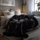 The black “Lava” blanket looks striking as a decorative throw on the sofa. Its luxurious faux fur enhances any interior with timeless elegance. Perfect for industrial, classic, and modern decor. A cozy companion for evenings with a book, tea, or a good movie