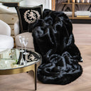 Make a dramatic style statement with our premium faux fur blanket in classic, opulent black. Rich in texture and sheen, this black faux fur throw is a masterpiece of modern luxury. Its thick, silky pile cascades over elegant seating, instantly elevating the space with a glamorous, fashion-forward touch. Paired with a regal decorative pillow, gold accents, and sleek glassware, this blanket is more than a cozy essential—it's a design centerpiece.